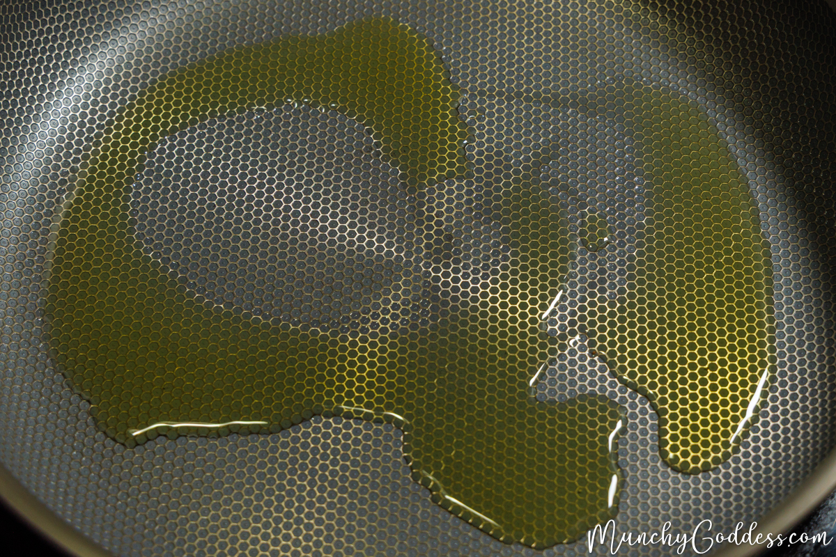 Olive oil added to a heated skillet.