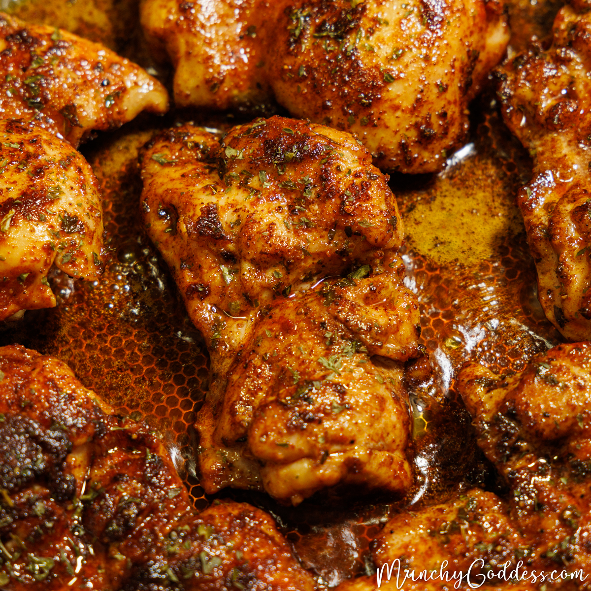 Pan seared chicken thighs in a skillet.
