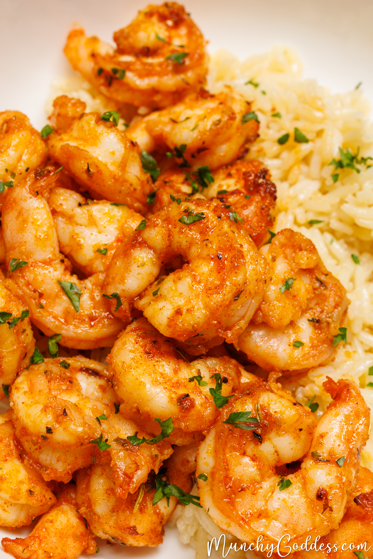 Shrimp on a bed of rice topped with fresh chopped parsley.
