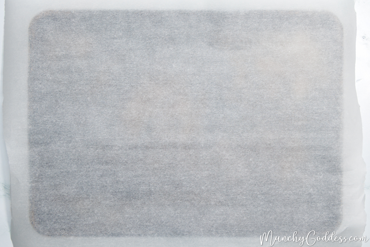 A sheet pan lined with parchment paper.
